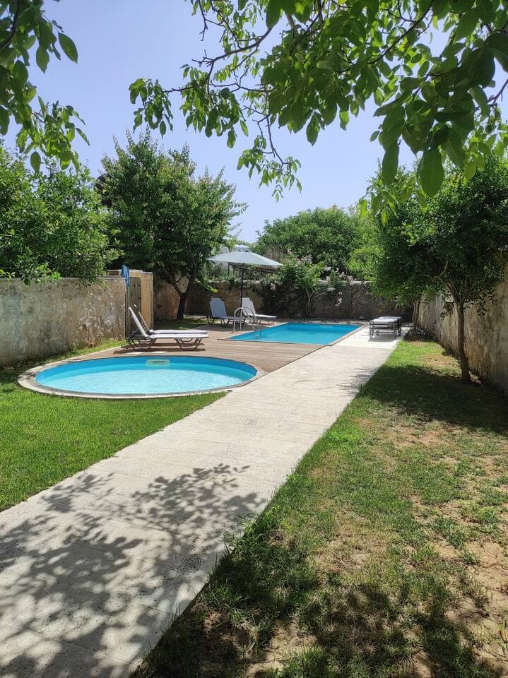 Walled pool garden with sun loungers